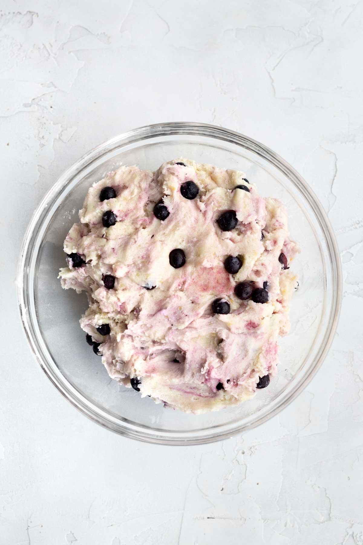 A bowl of Lemon Blueberry Cookie dough with regular frozen blueberries.