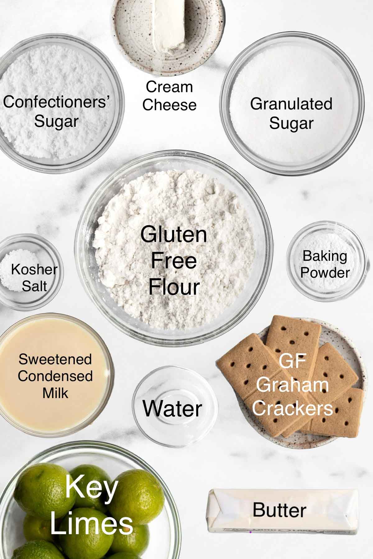 Confectioners' sugar, cream cheese, sugar, kosher salt, gluten free flour, baking powder, sweetened condensed milk, water, graham crackers, key limes, and butter in separate containers.