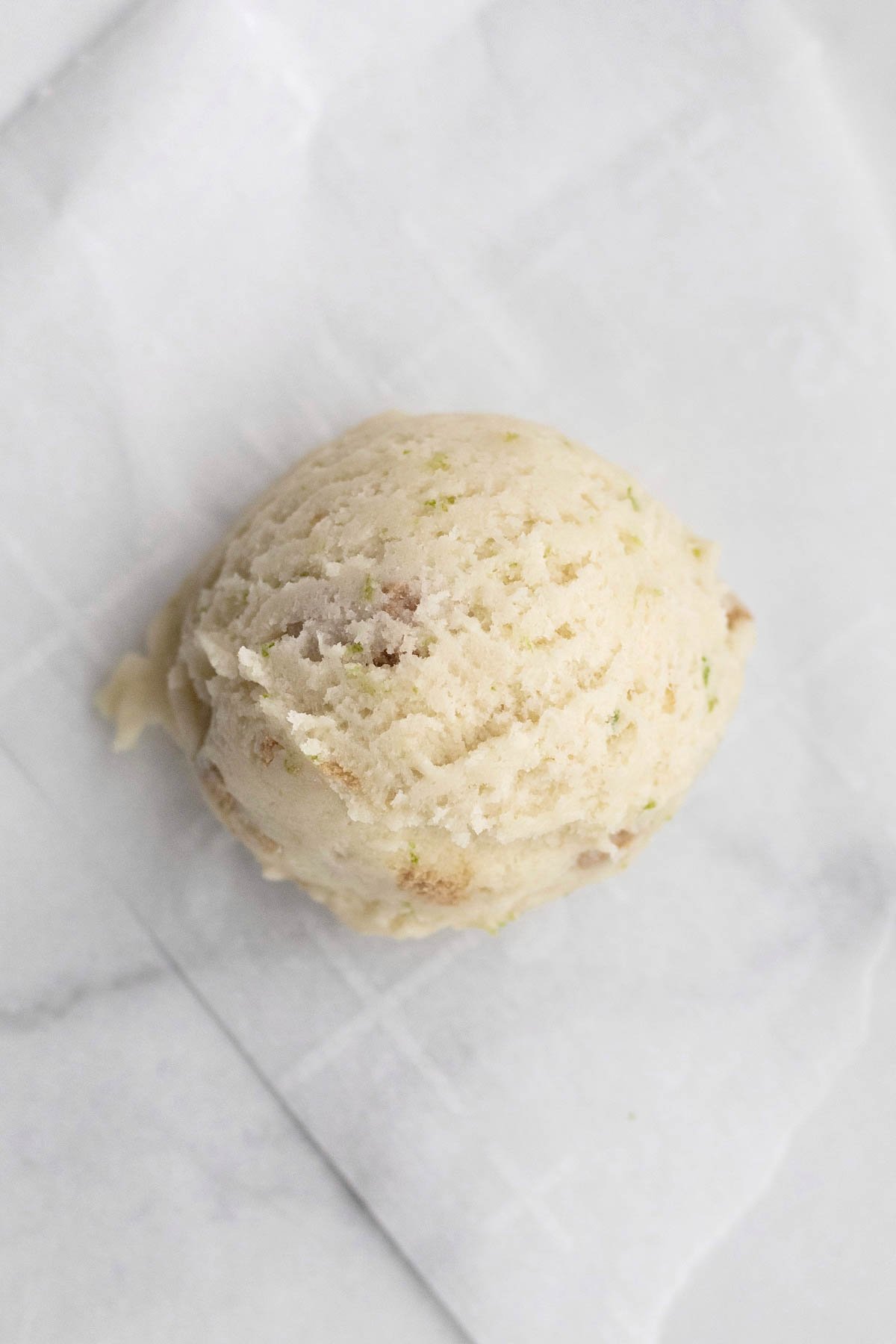 A scooped ball of key lime cookie dough.