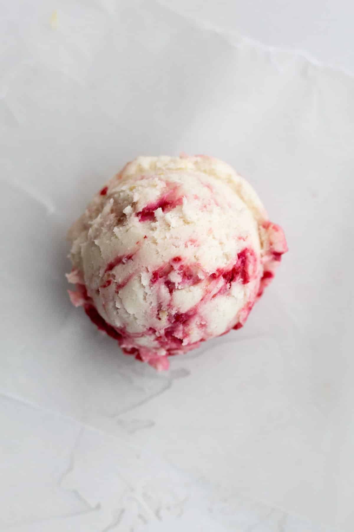 A scooped ball of Lemon Raspberry Cookie dough.