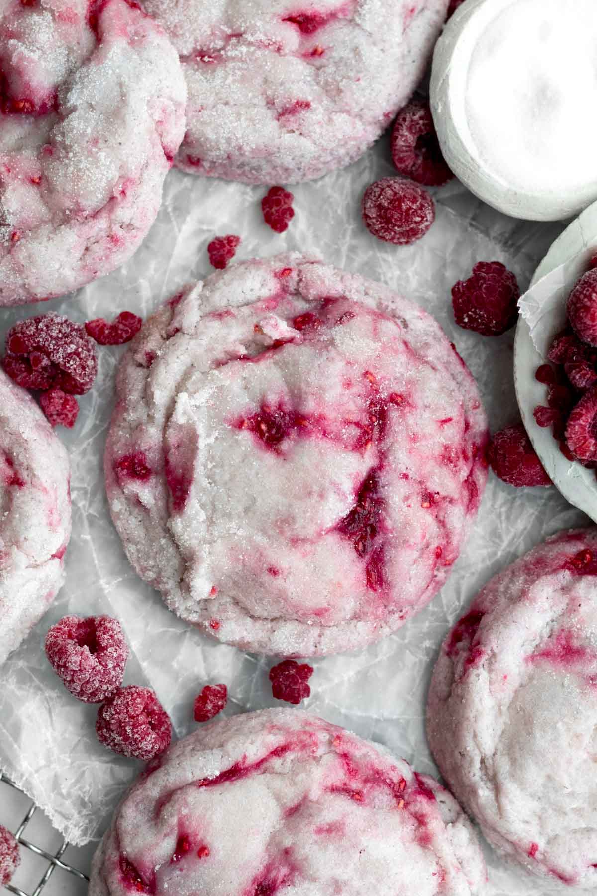 Red flecks of raspberry contrast with the pale dough of Raspberry Cookie without red food coloring.