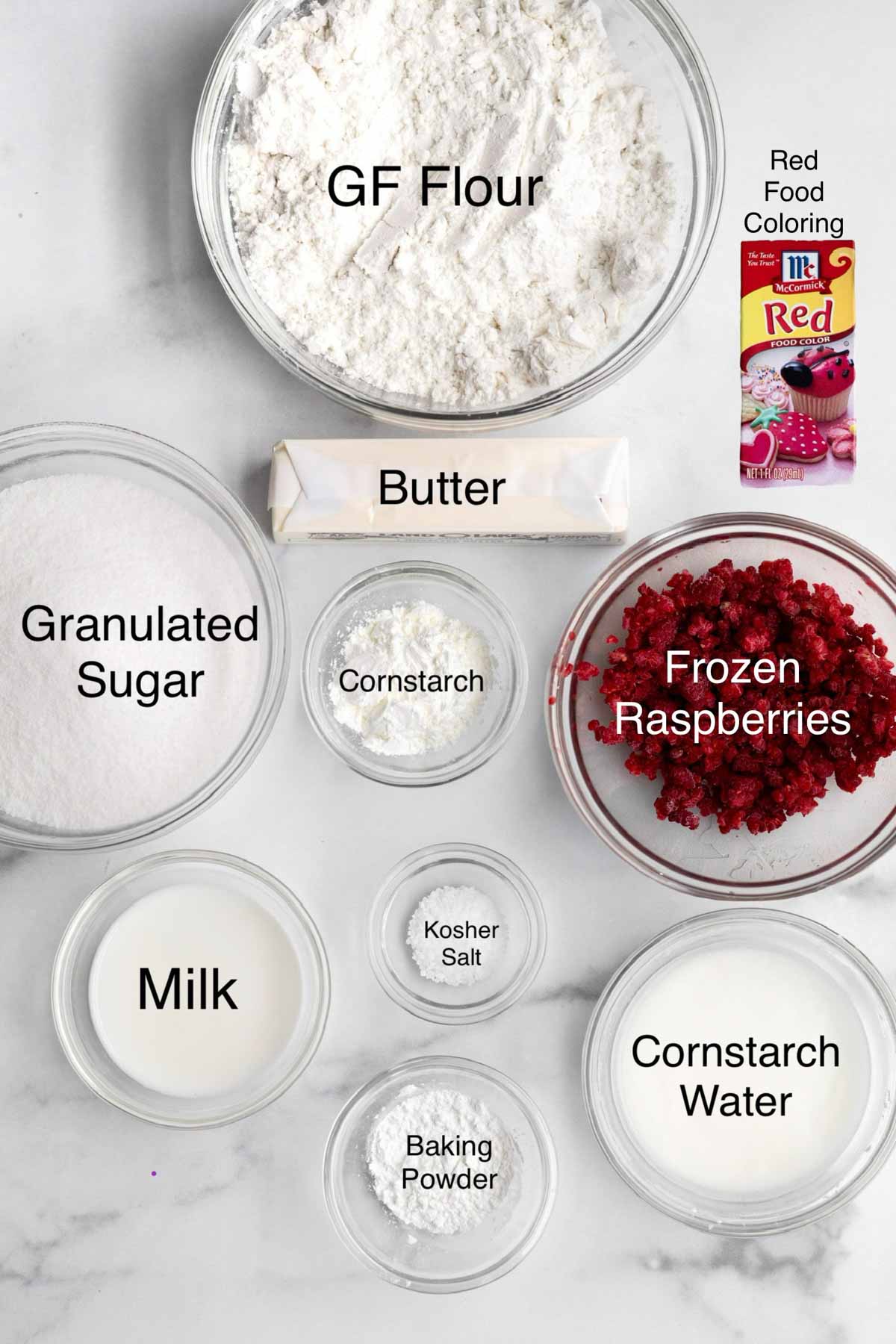 Gluten free flour, butter, red food coloring, granulated sugar, cornstarch, frozen raspberries, milk, kosher salt, cornstarch water, and baking powder in separate containers.