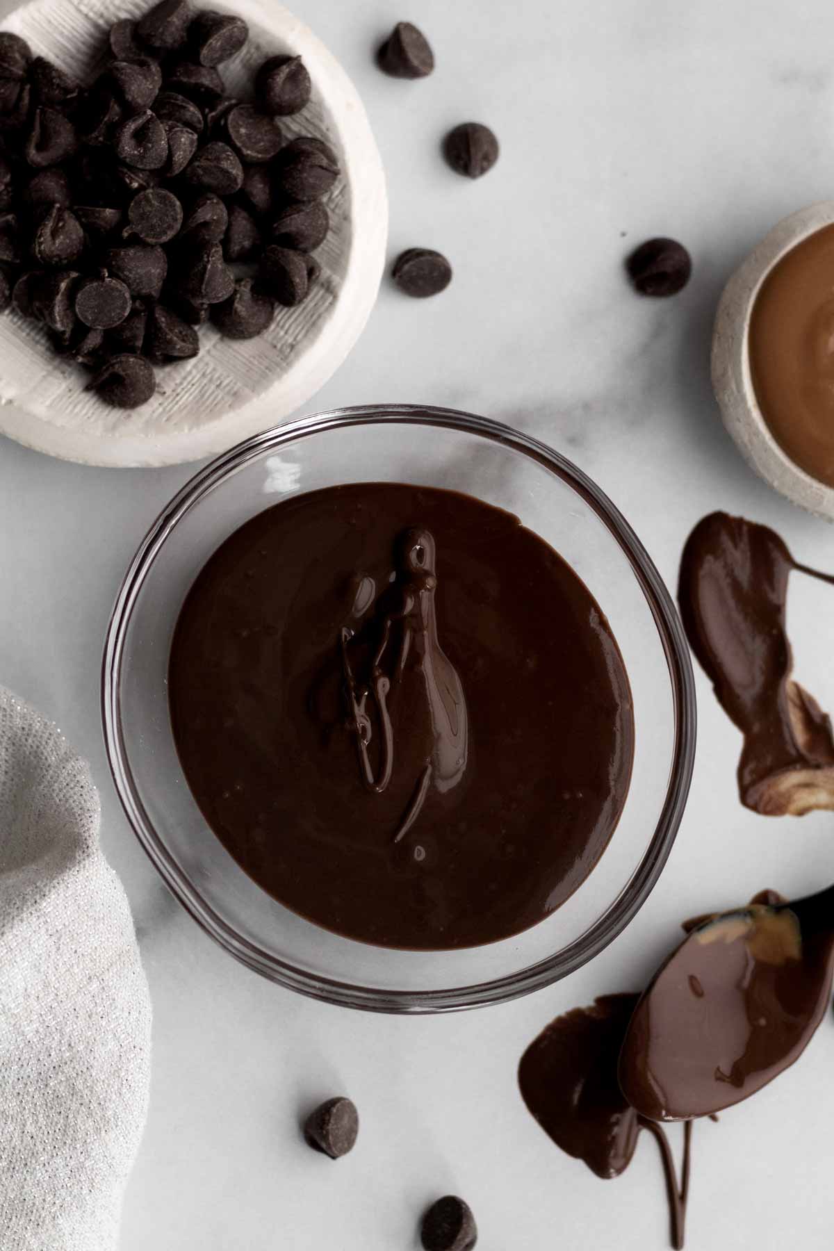 Rich melted chocolate and wow butter in a small glass bowl.