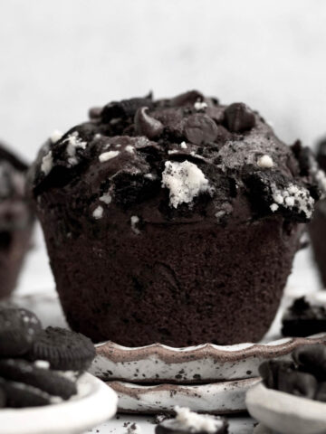 A perfect baked Oreo Muffin with broken chocolate sandwich cookies and chocolate chips.