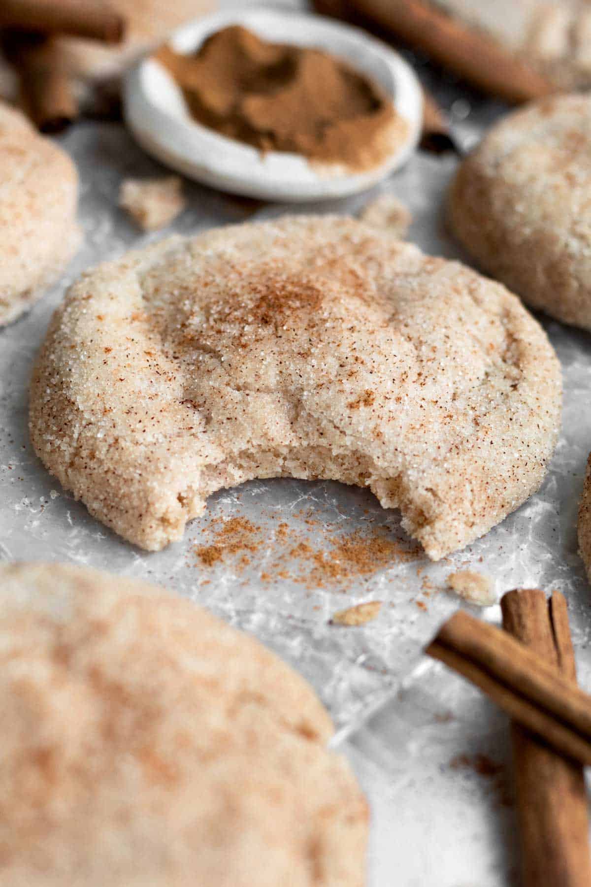 A bite reveals the soft interior of the Gluten Free Snickerdoodle Cookie.