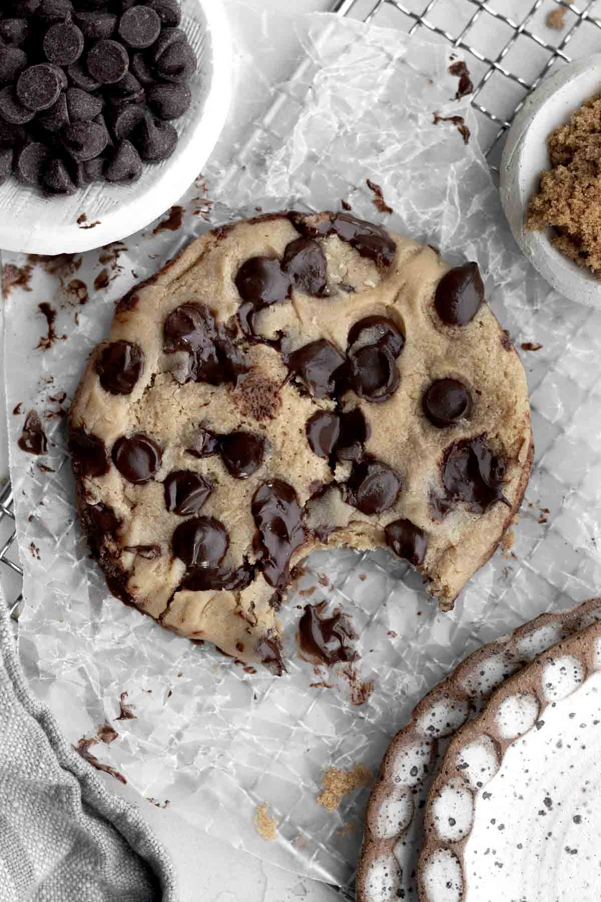 A Microwave Chocolate Chip Cookie with a bite taken, ready to be continued to be enjoyed.