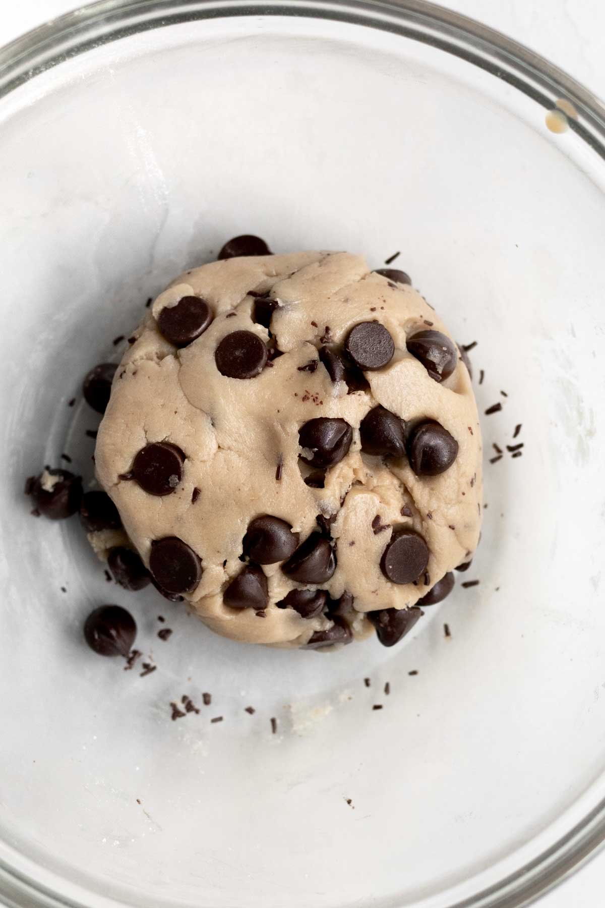 Mixing in chocolate chips into the cookie dough batter.