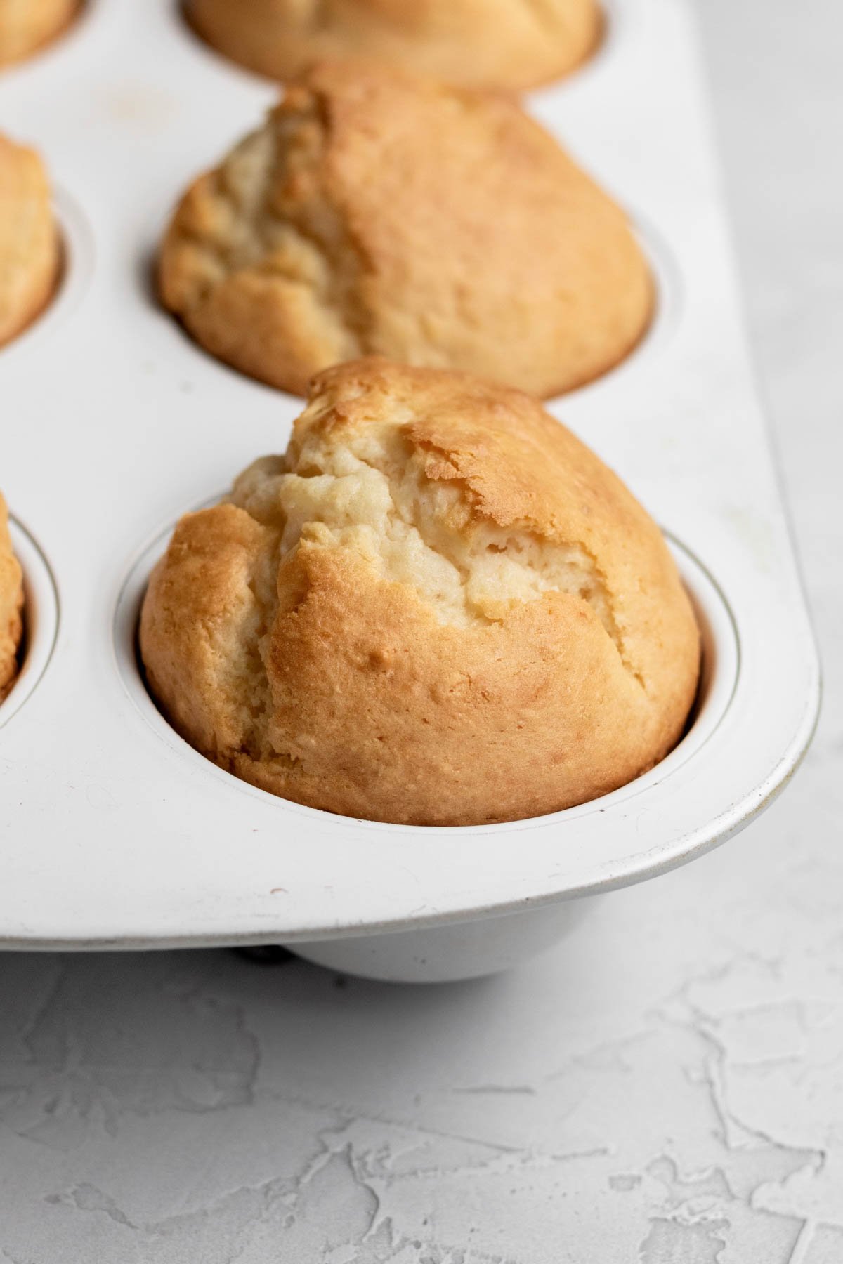 Delicious Vanilla Muffins baked perfectly in the muffin tin.