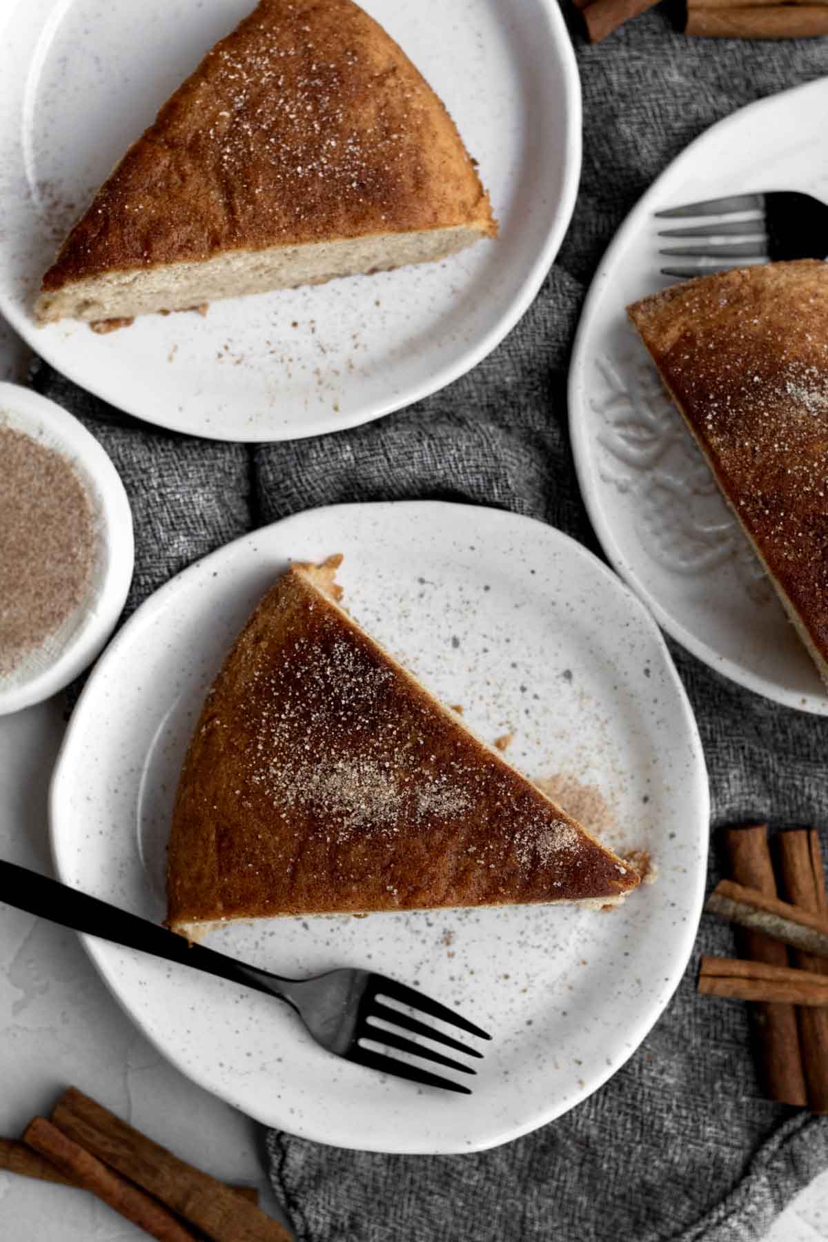 Three light and fluffy perfect slices of Cinnamon Tea Cake with delicious cinnamon sugar topping.