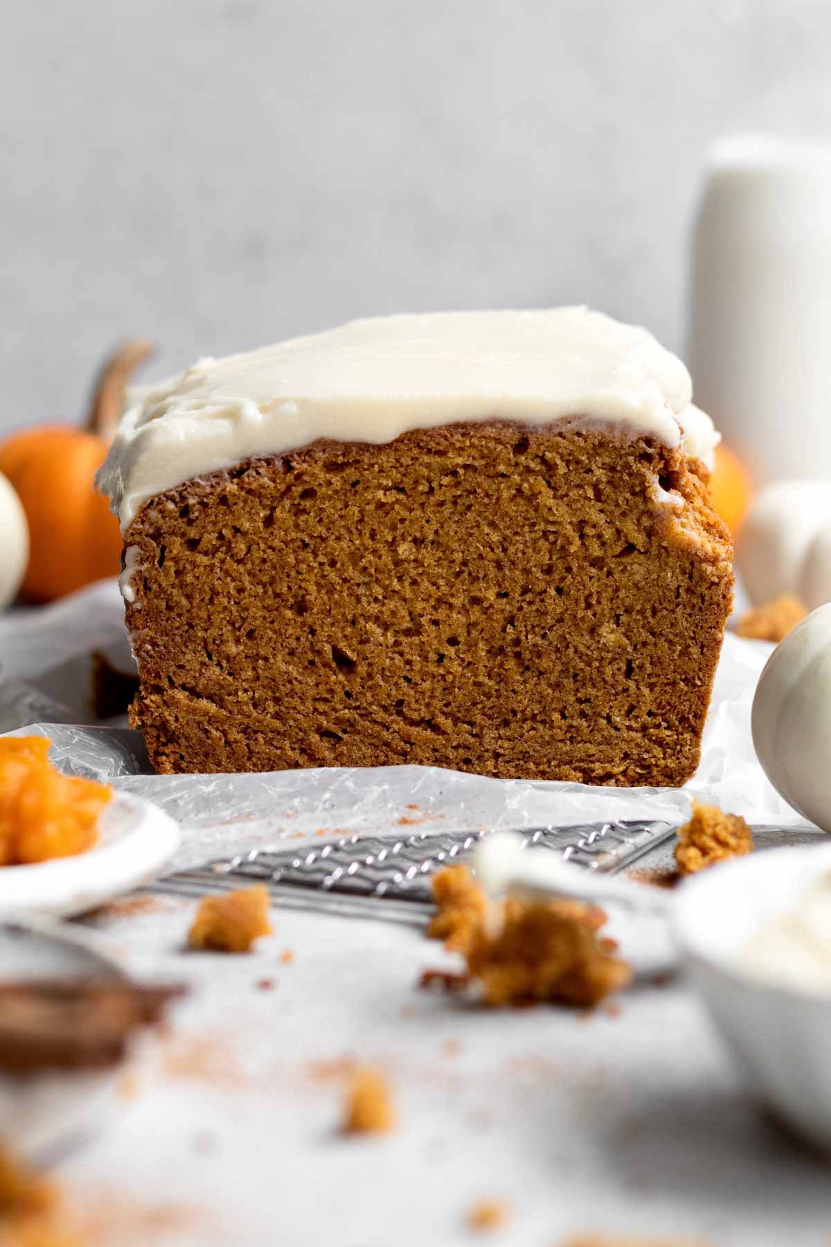 A loaf of pumpkin Bread topped with sweet and delicious cream cheese frosting.