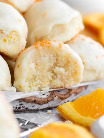 A bite reveals the tender tangy moist crumble inside of the Orange Shortbread Cookies.