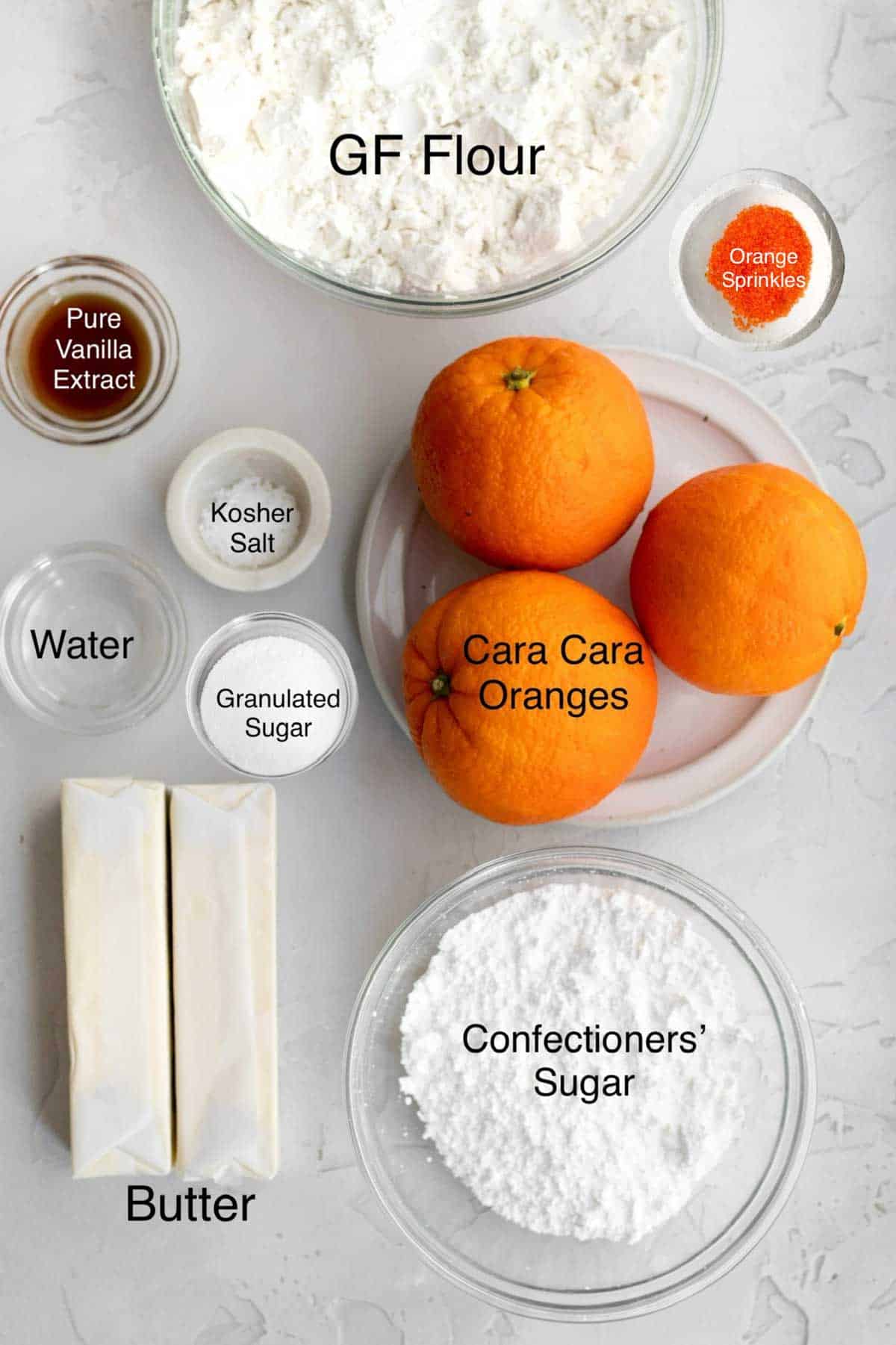 Gluten free flour, pure vaniila extract, orange sprinkles, cara cara oranges, water, kosher salt, granulated sugar, butter, confectioners' sugar in separate containers.