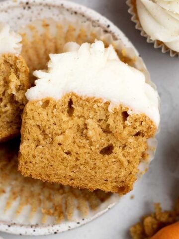 A perfect halved Pumpkin Cupcake reveals its light and fluffy interior.