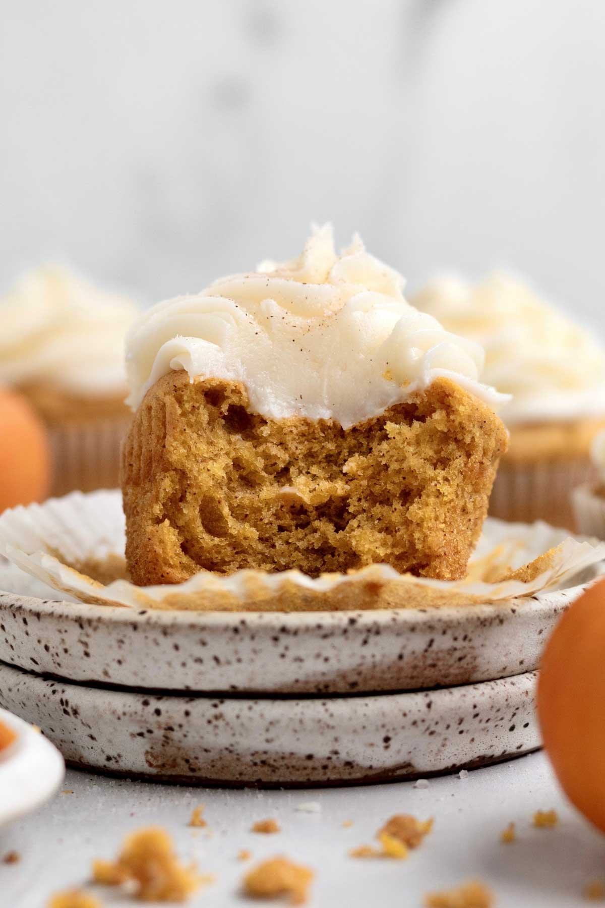 A bite cascades though the cinnamon sugar topped cream cheese frosting and into the Pumpkin Cupcake.