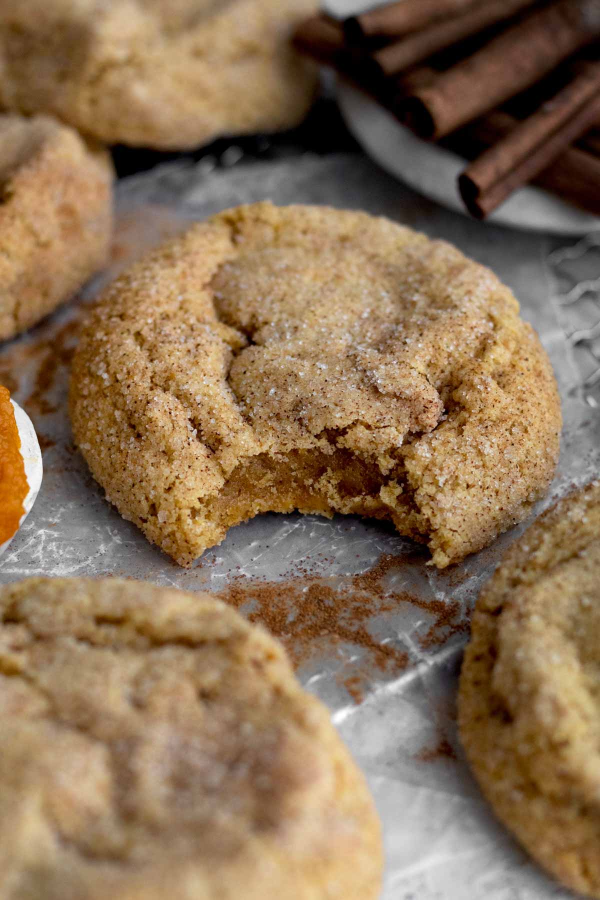 Biting into the Pumpkin Snickerdoodle Cookie cracks its crispy exterior, revealing a cozy, deliciously soft interior.