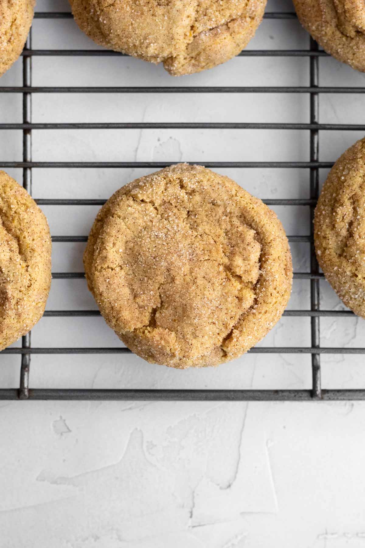 Perfectly baked Pumpkin Snickerdoodle Cookies on a cooling rack.