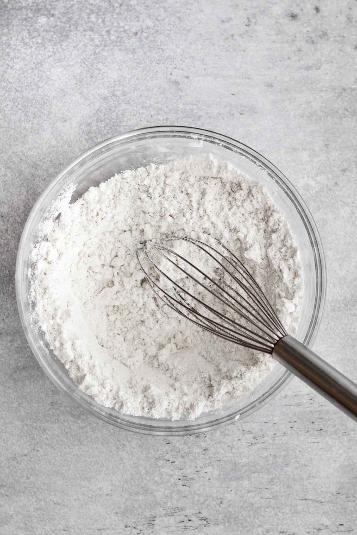 A whisk with the white dry ingredients.