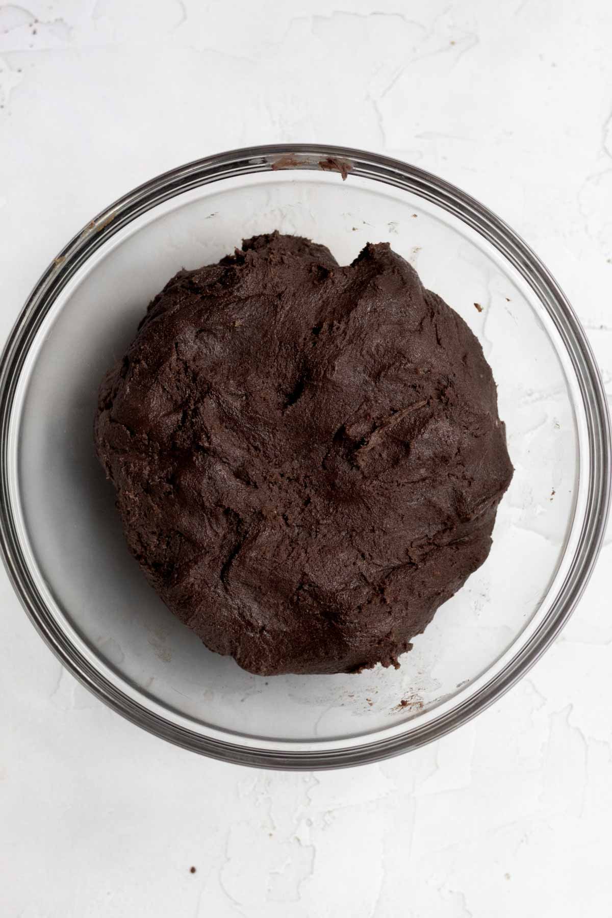Mixing the wet and and dry ingredients into a dark chocolatey cookie batter.