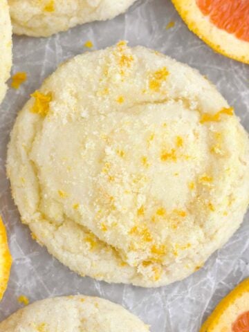 A delicious sugary Orange Cookie with bright tangy flecks of orange zest embedded throughout.