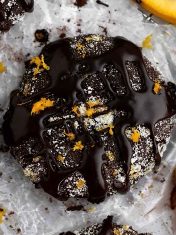 Drizzled chocolate gleams atop a sugary Chocolate Orange Cookie with bright tangy flecks of orange zest.