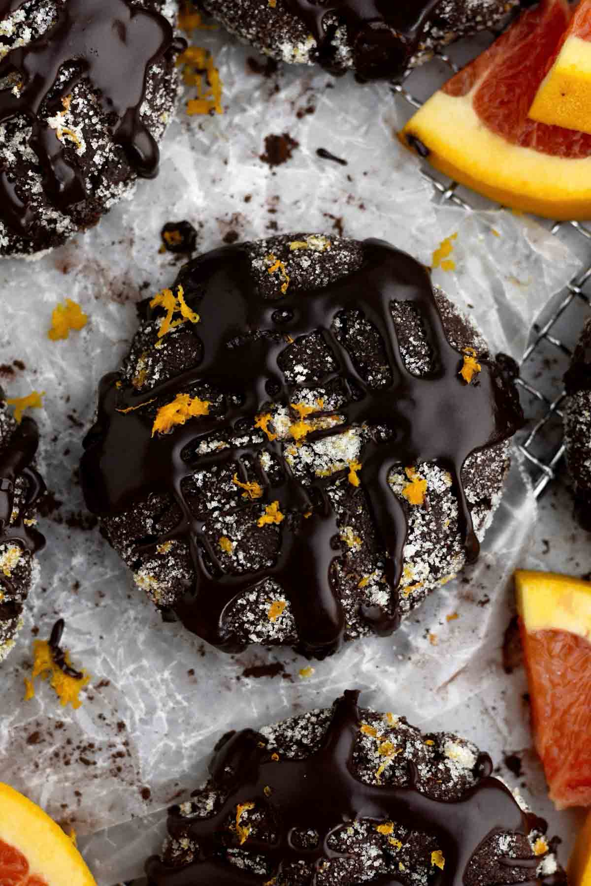 Drizzled chocolate gleams atop a sugary Chocolate Orange Cookie with bright tangy flecks of orange zest.