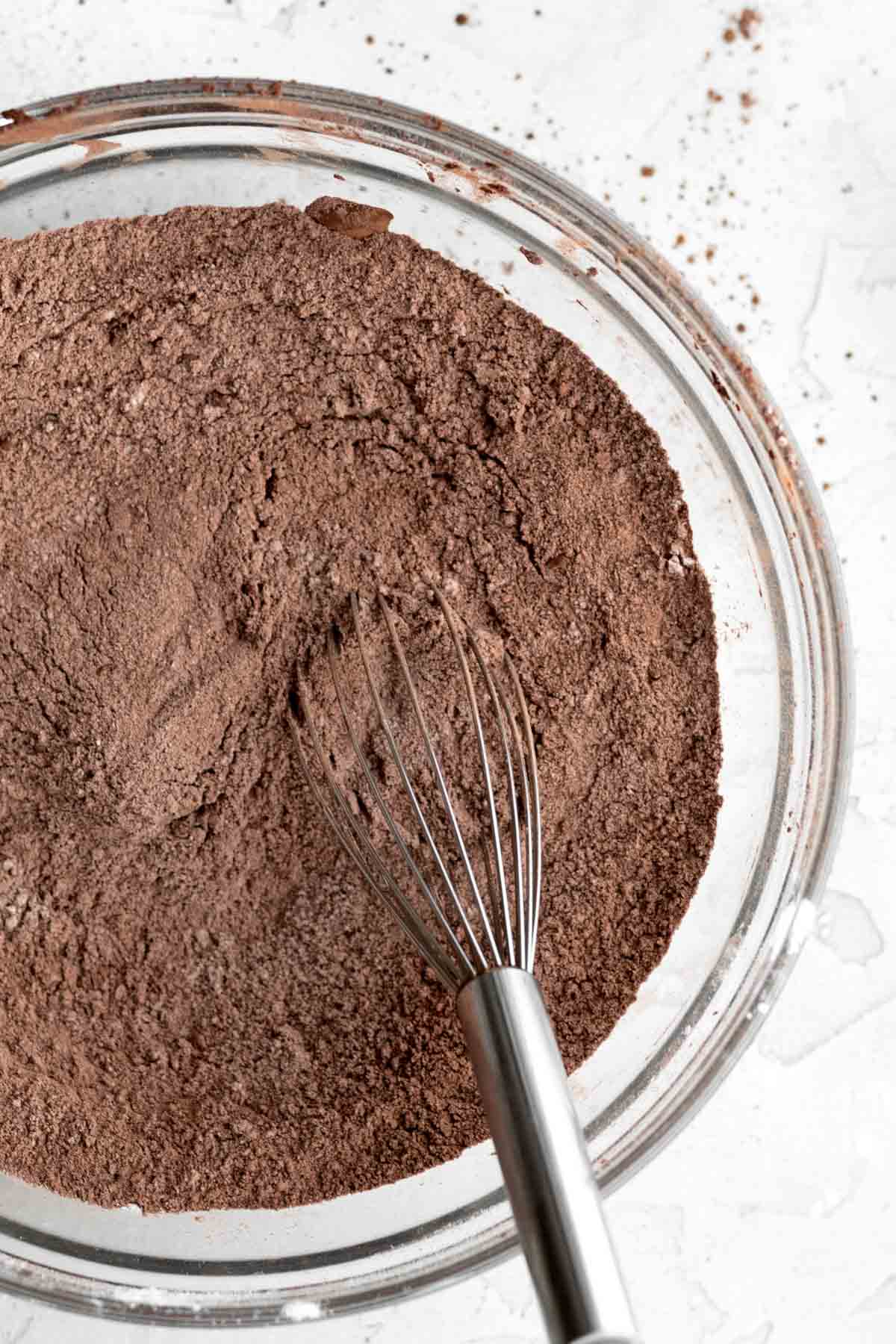 A whisk with the chocolate dry ingredients.