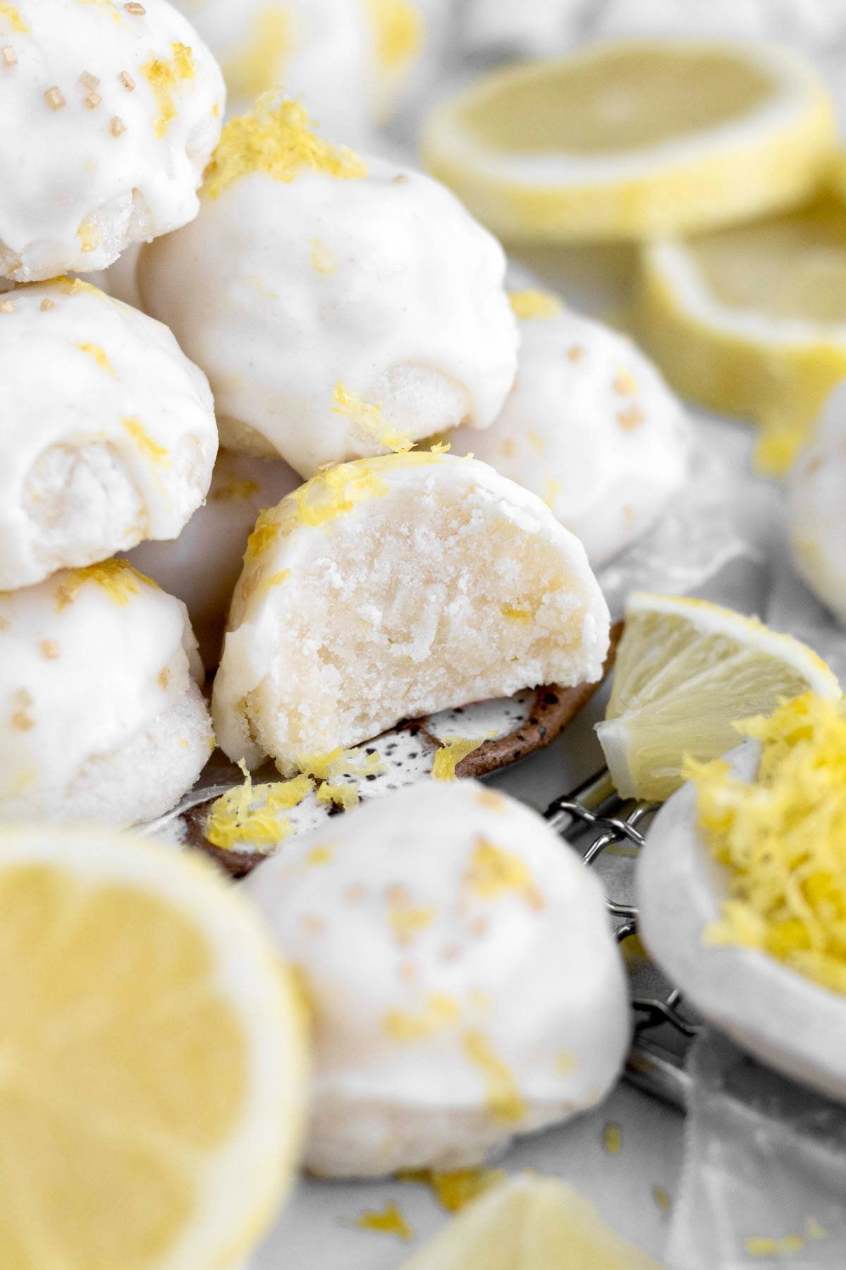 A bite reveals the soft buttery interior of the Lemon Shortbread Cookie balls.