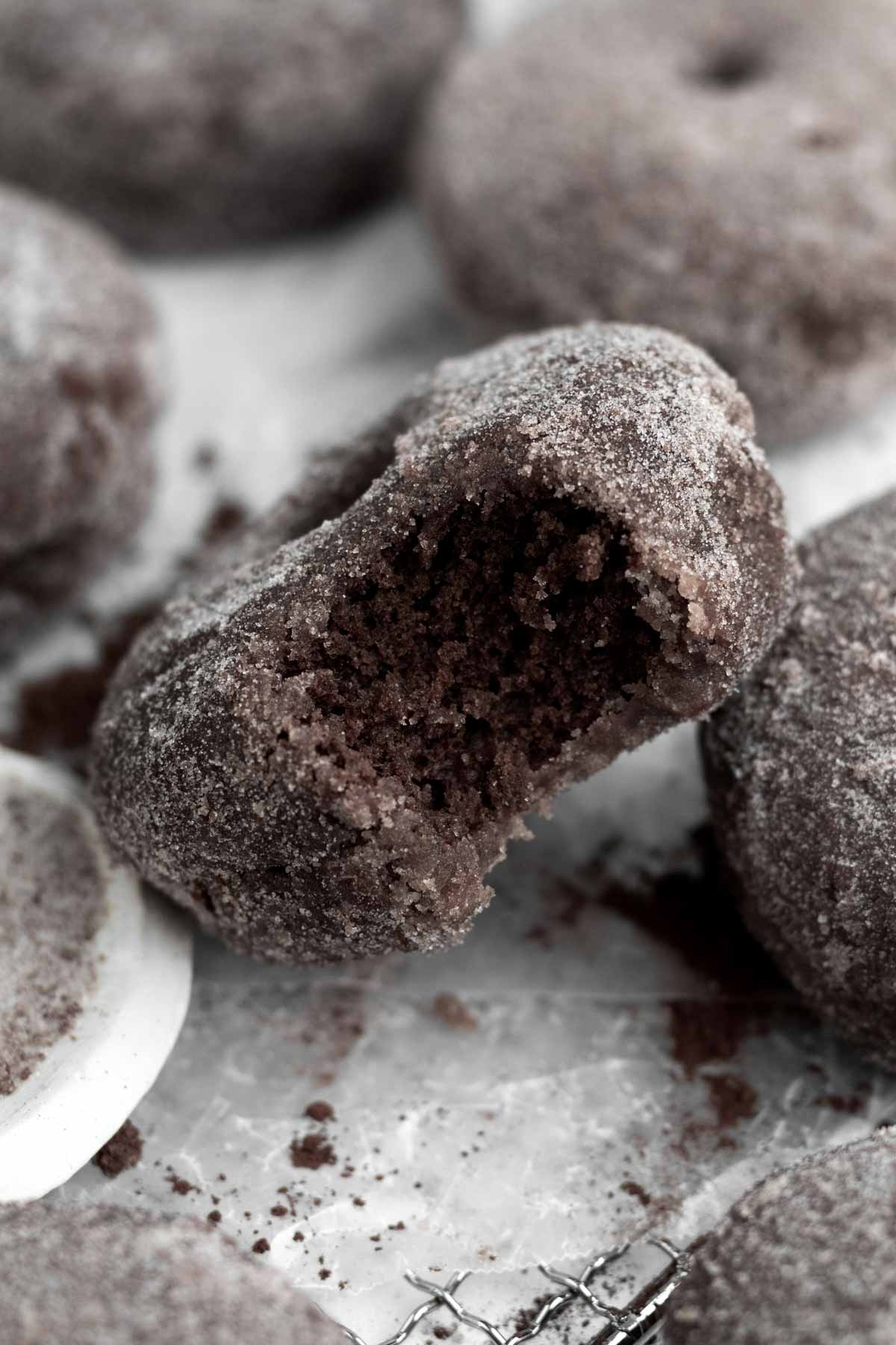 A bite in the sweet crystalized Chocolate Sugared Donuts reveals a warm soft cocoa interior.