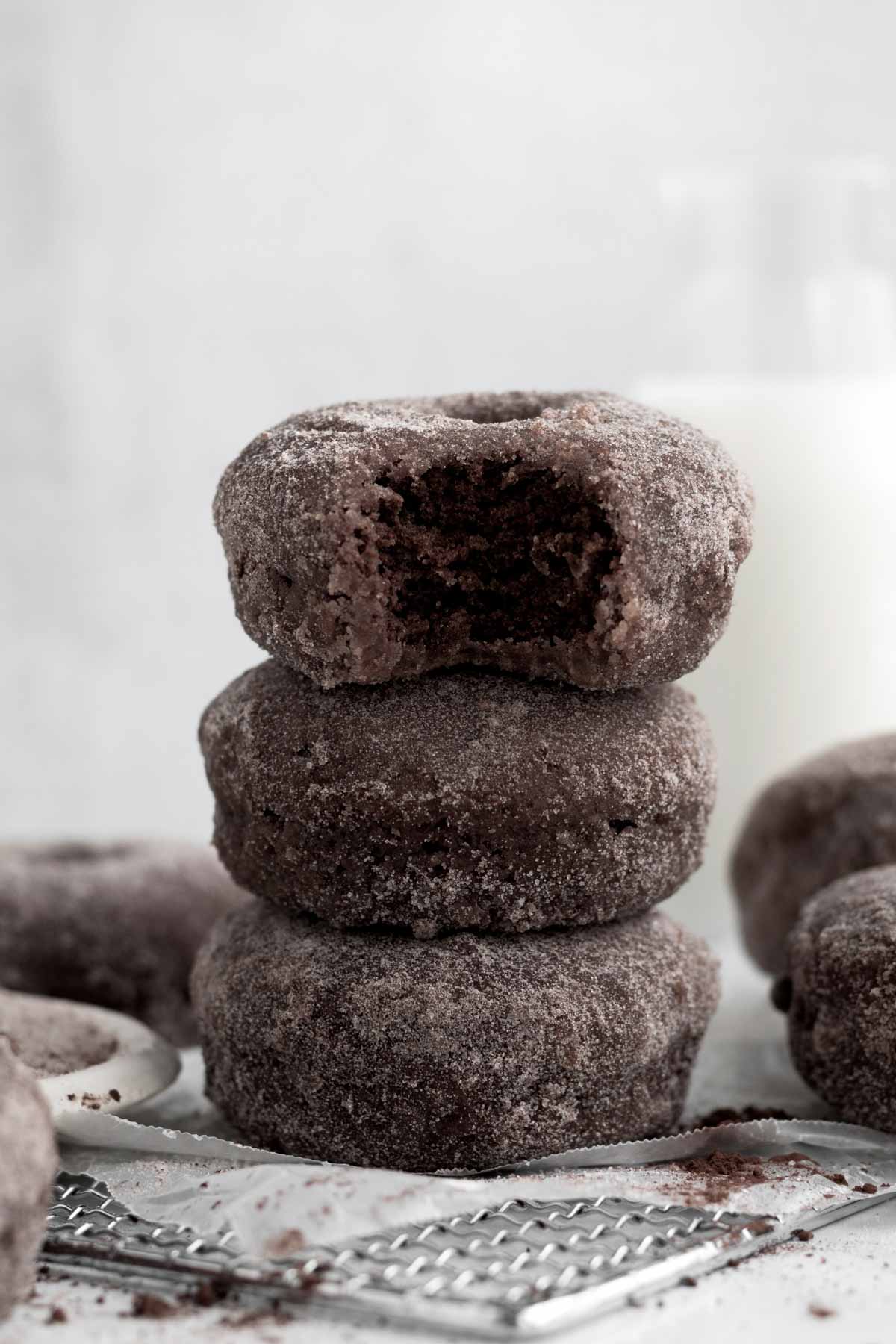 A tower of three Chocolate Sugared Donuts awaits your hands.
