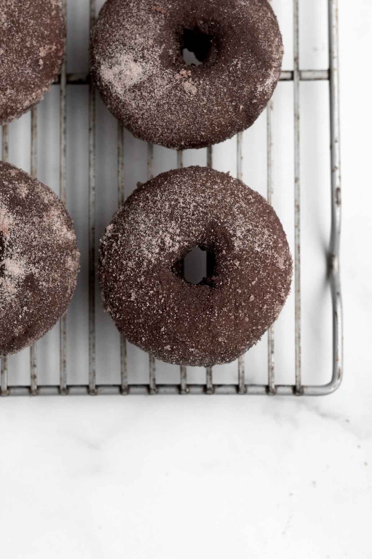 The fist coat of cocoa sugar on the donuts.