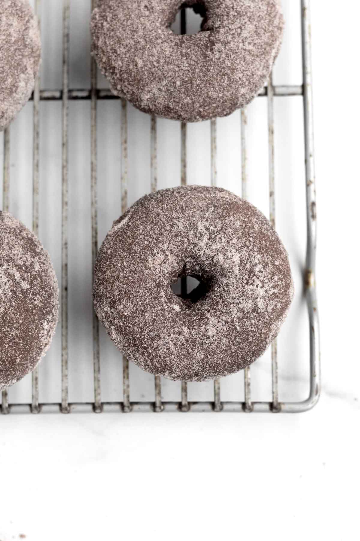 The second coat of cocoa sugar completes the Chocolate Sugared Donuts.