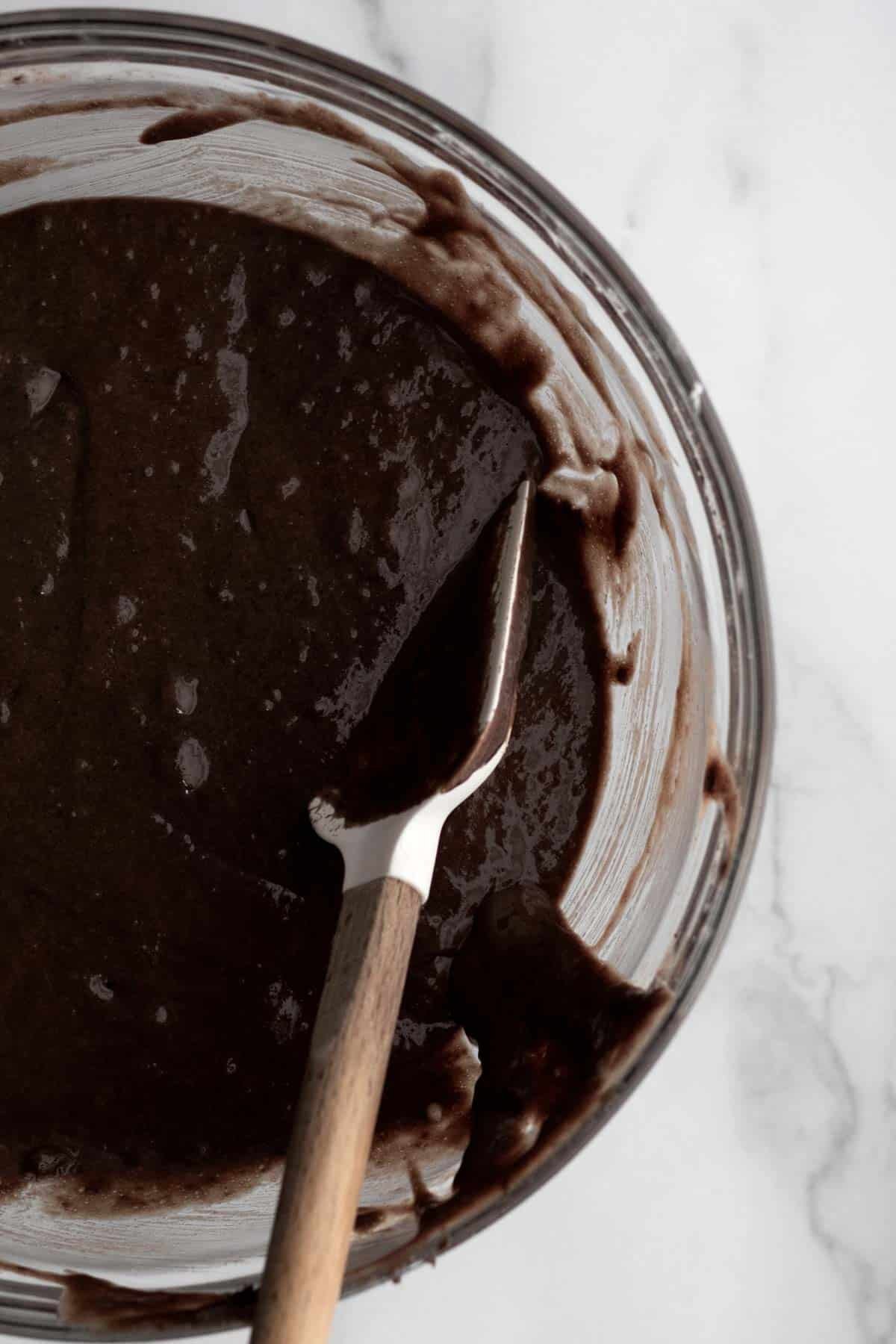 Mixing the wet and dry ingredients into a chocolatey donut batter.