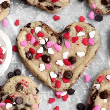 Heart Shaped Chocolate Chip Cookie with gooey chips and sugary pink, red and white heart sprinkles.