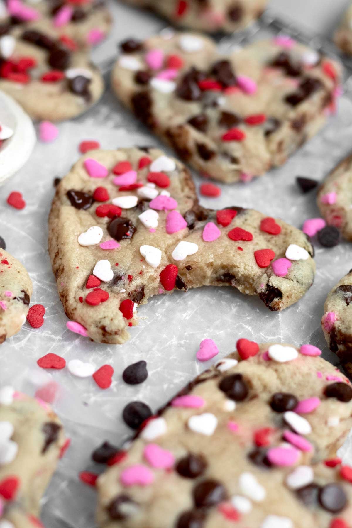 A bite in the soft Heart Shaped Chocolate Chip Cookie crunches through the heart sprinkles.