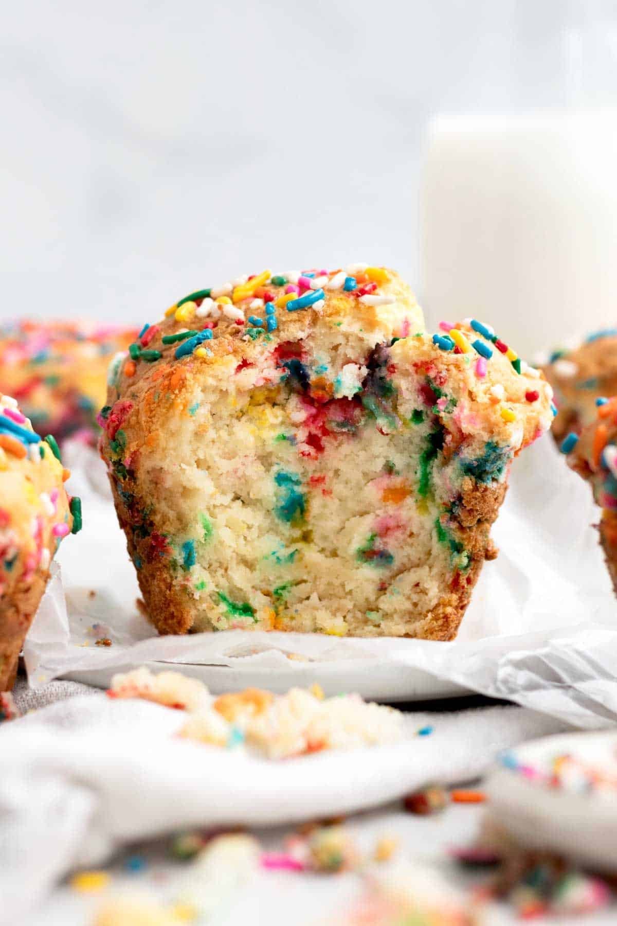 A bite reveals a light soft interior with dashes of rainbow infusions in this Birthday Muffin.