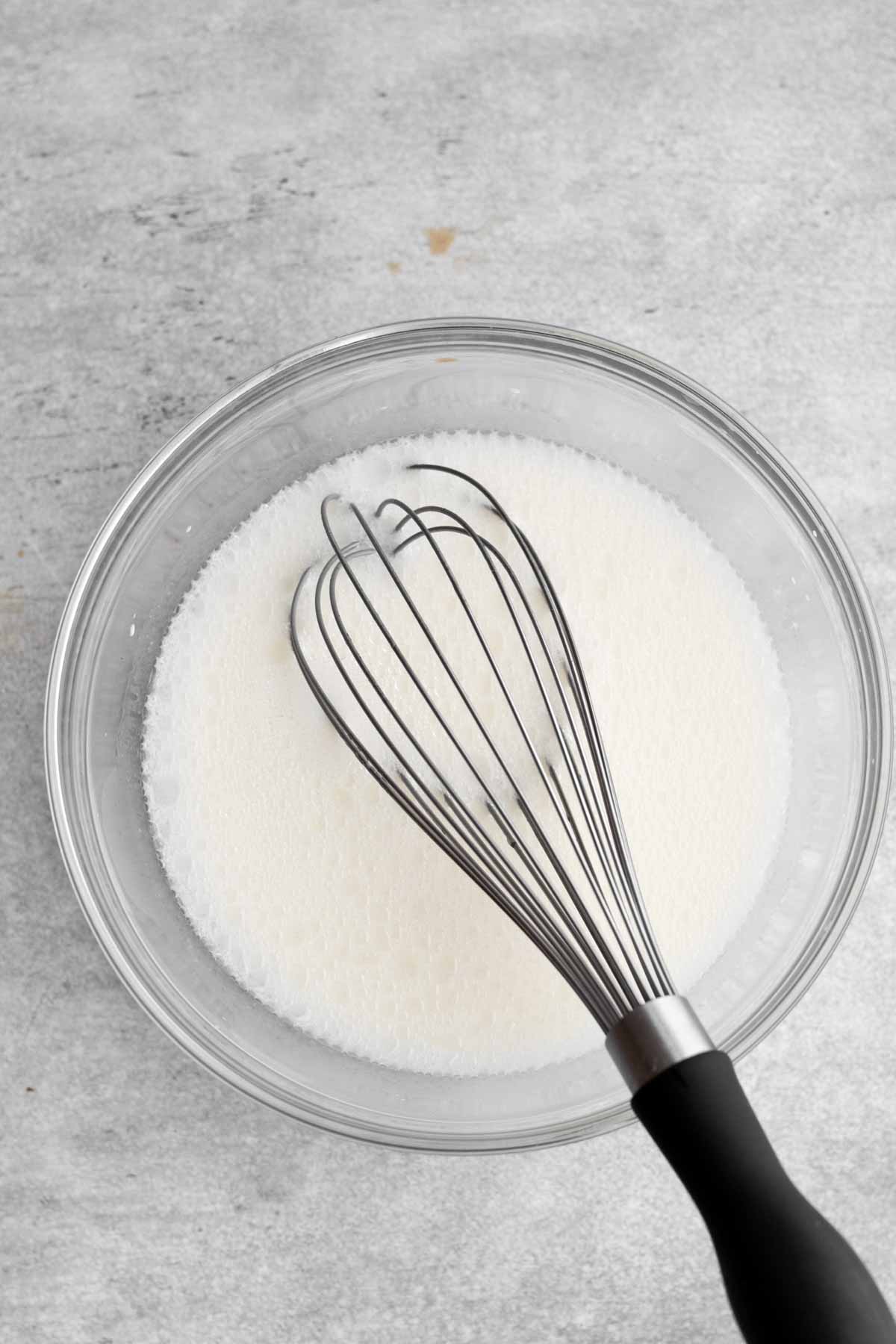 Whisking the milky white wet ingredients together.