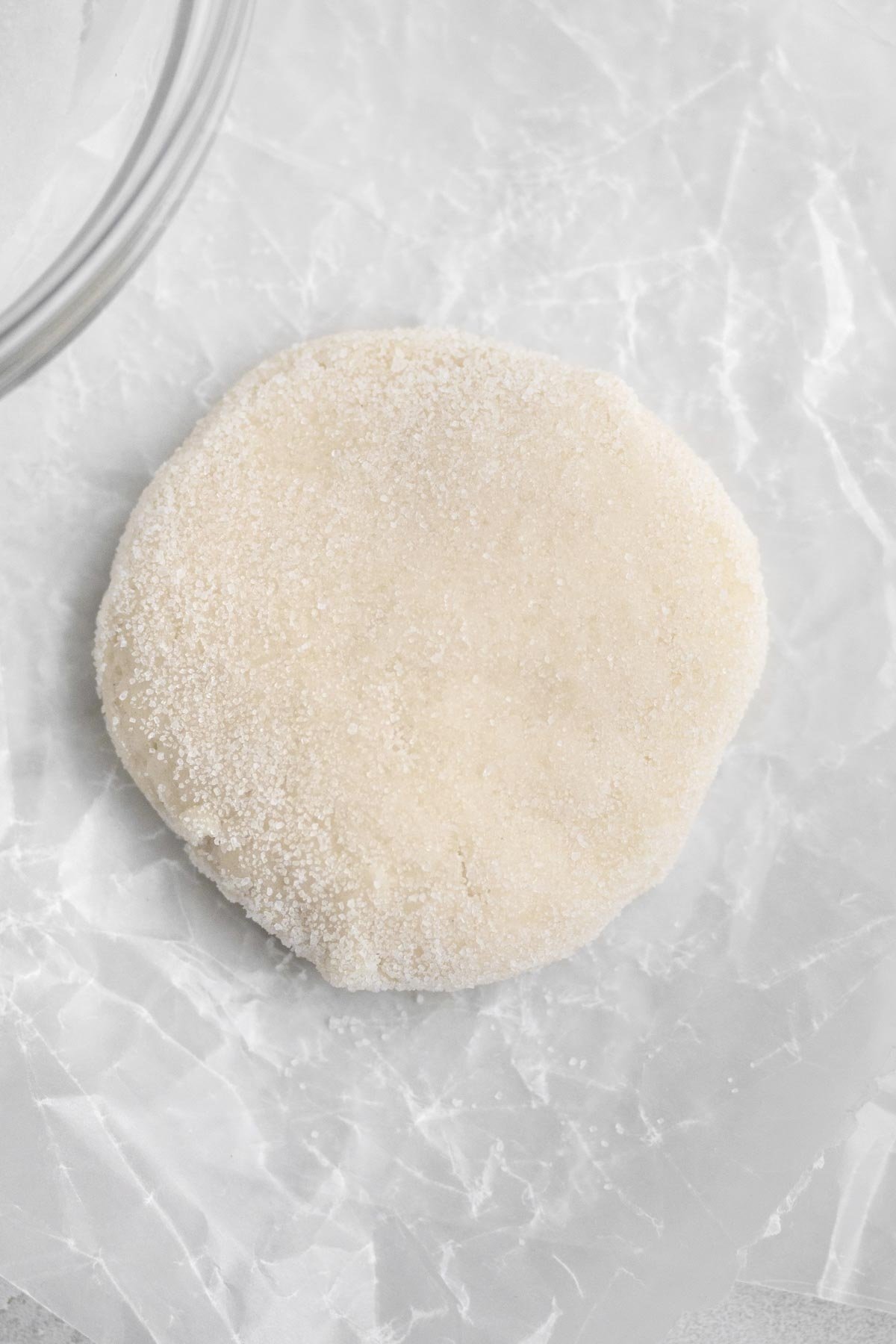Granulated sugar is pressed into the dough disc.