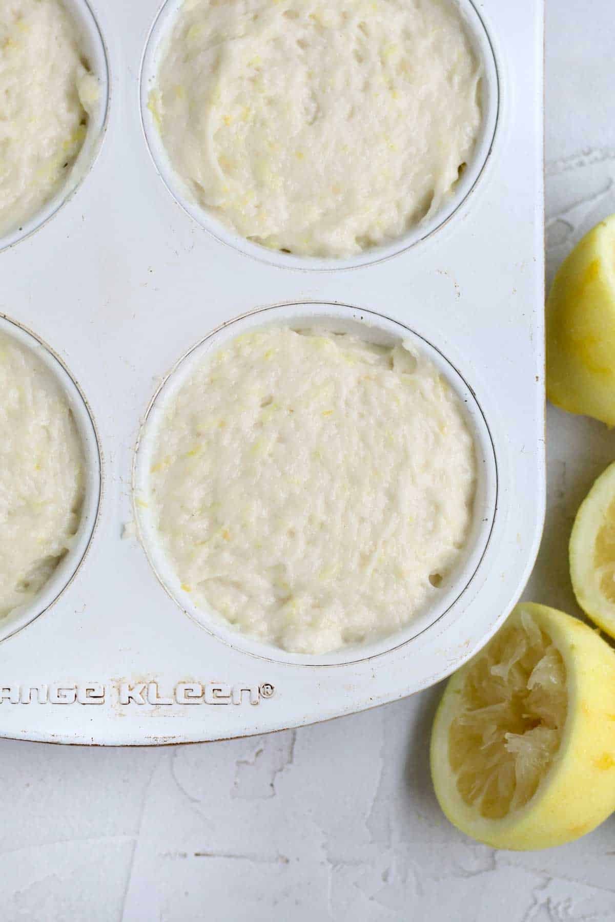 Filling a large muffin tin with the Lemon Muffin batter.