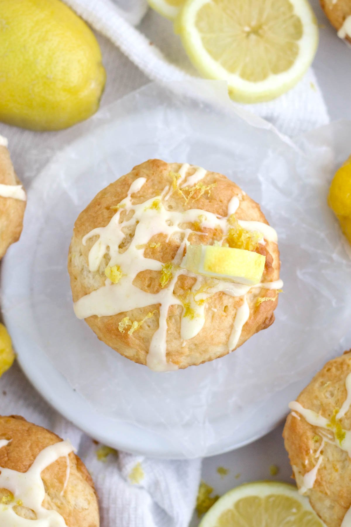 Sugary glaze is strewn atop this Lemon Muffin brightened by flakes of flavorful lemon zest.