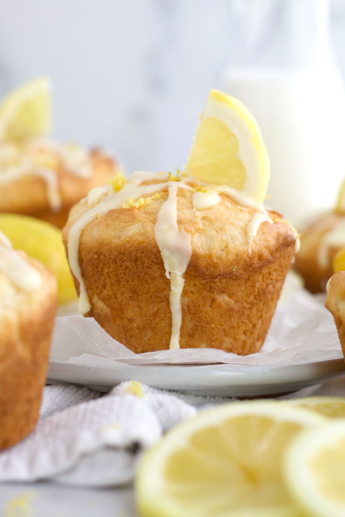 A lemon wedge sits like a flag of deliciousness on this light and zesty Lemon Muffin.