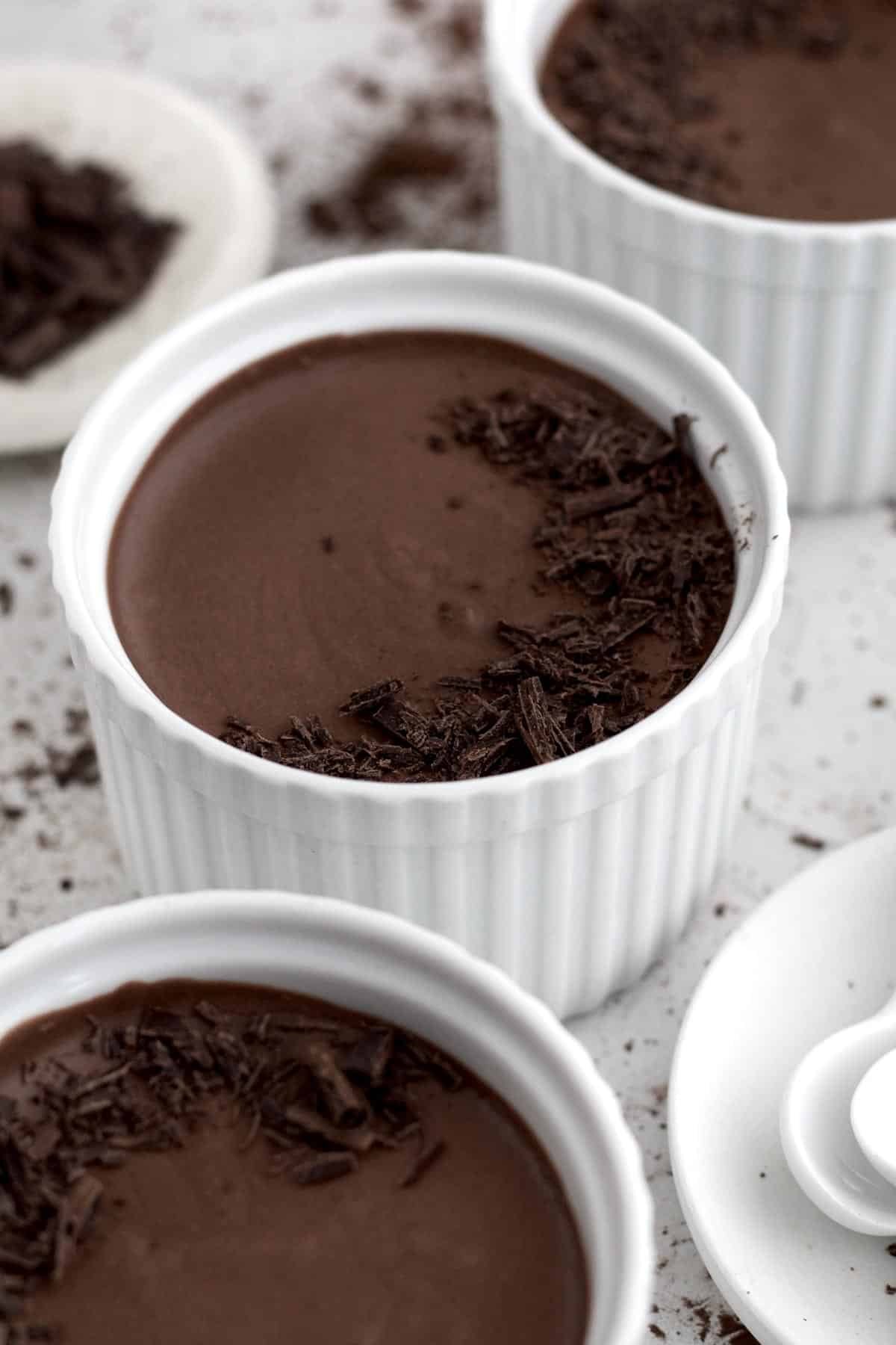 Easy Eggless Chocolate Mousse topped with a crescent moon of shaved curls of chocolate.