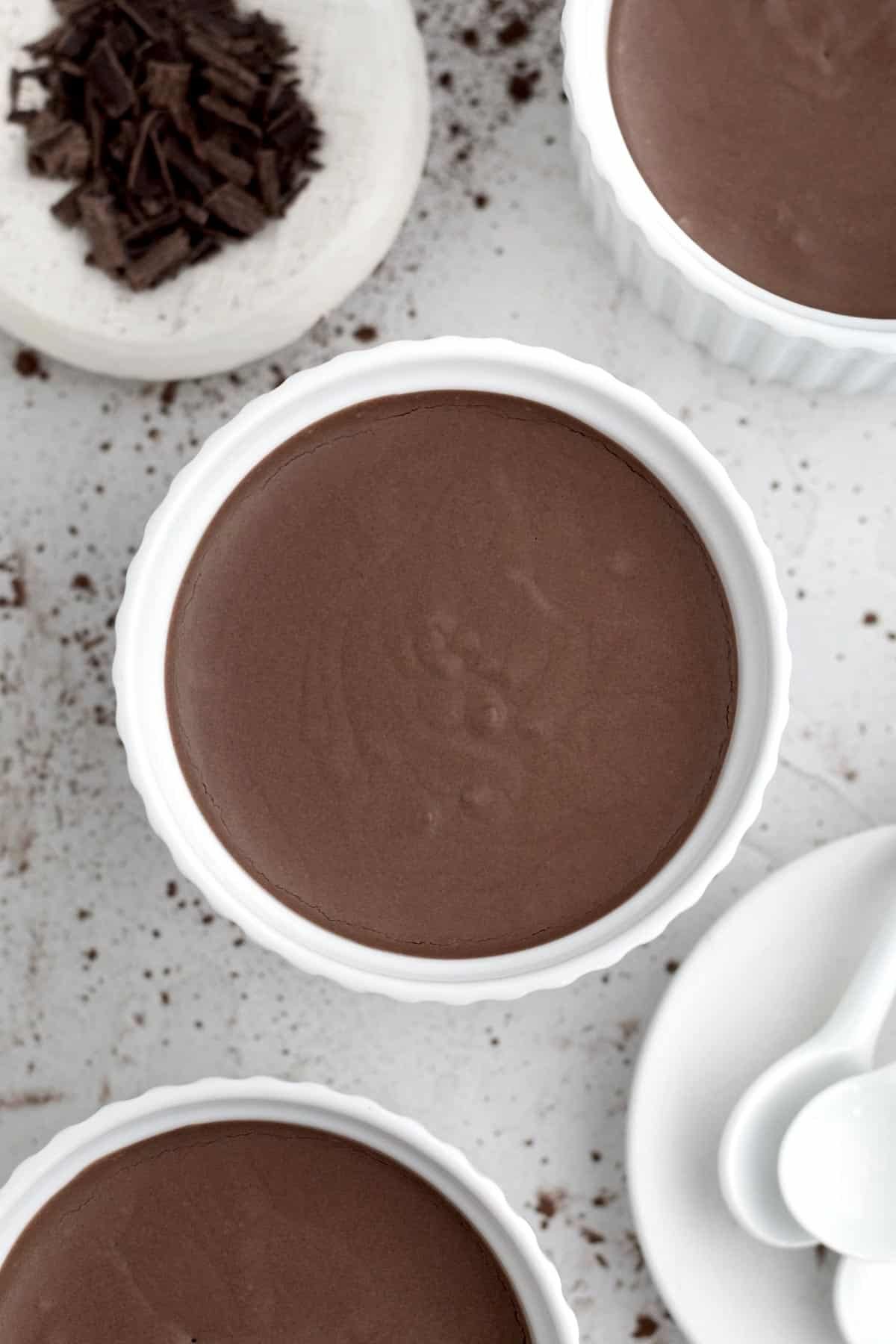 Filling the round white ramekins with the rich Easy Chocolate Mousse.