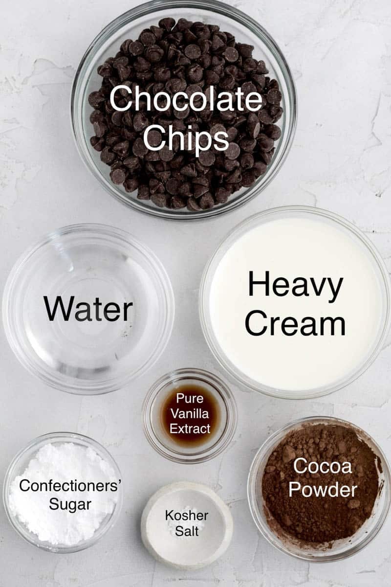 Bowls of chocolate chips, water, heavy cream, pure vanilla extract, confectioners' sugar, kosher salt and cocoa powder.