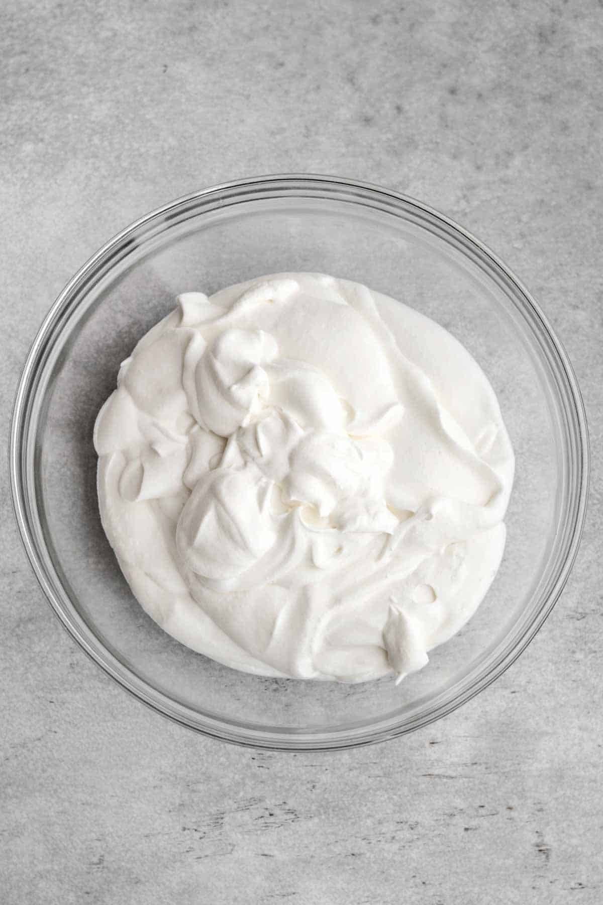 White and delicious whipped cream in a bowl.