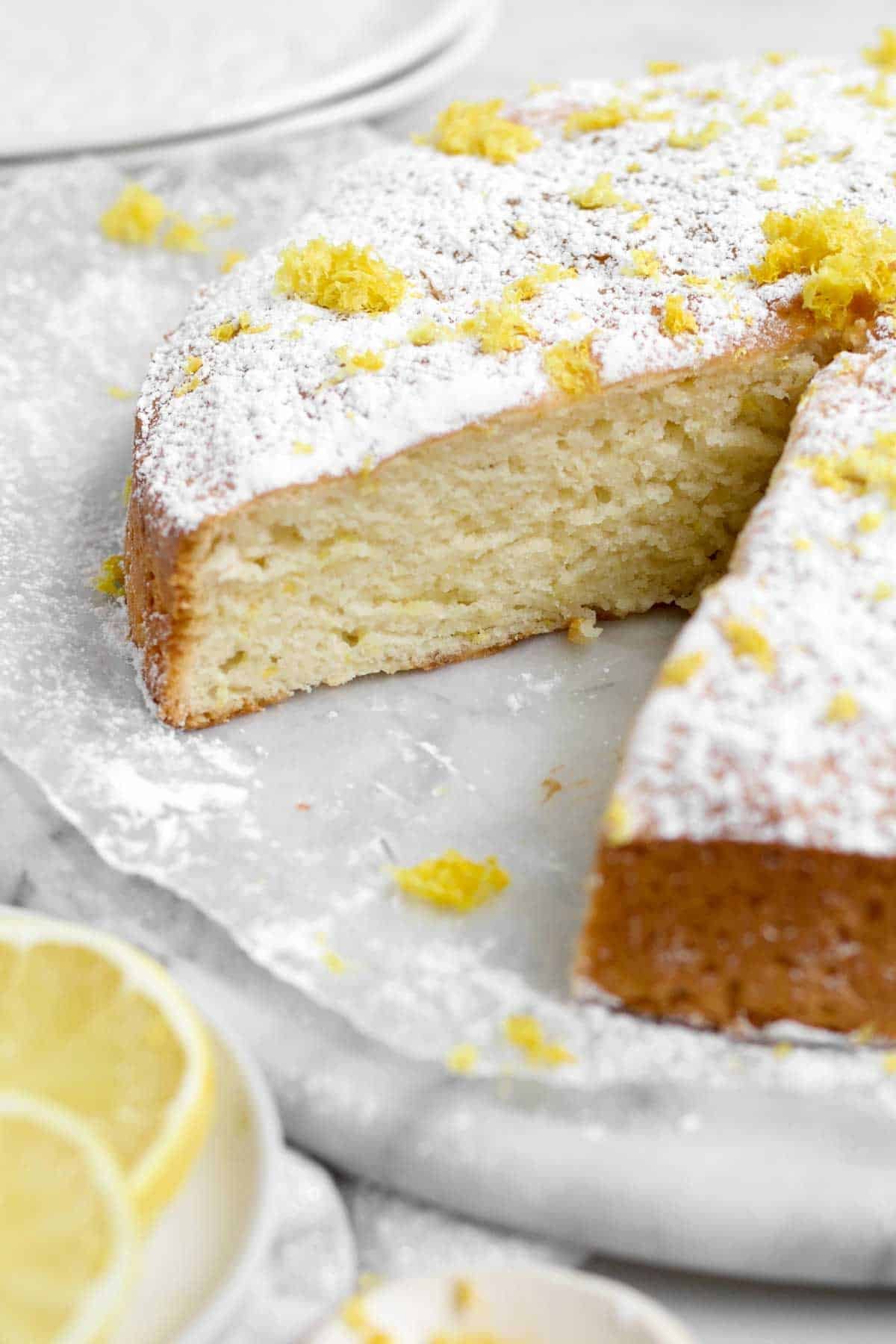 A removed slice showcases the spongy, light and moist interior of the Lemon Tea Cake.