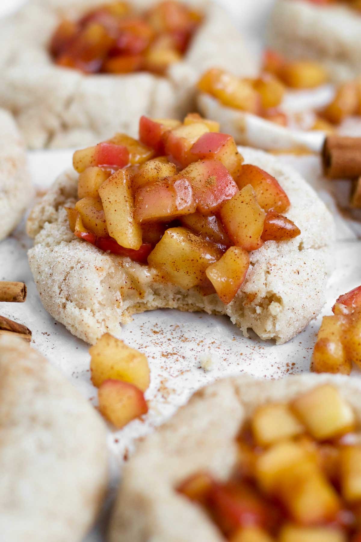 A bite in the glute free Apple Pie Cookie reveals the cinnamon spiced warm soft interior.