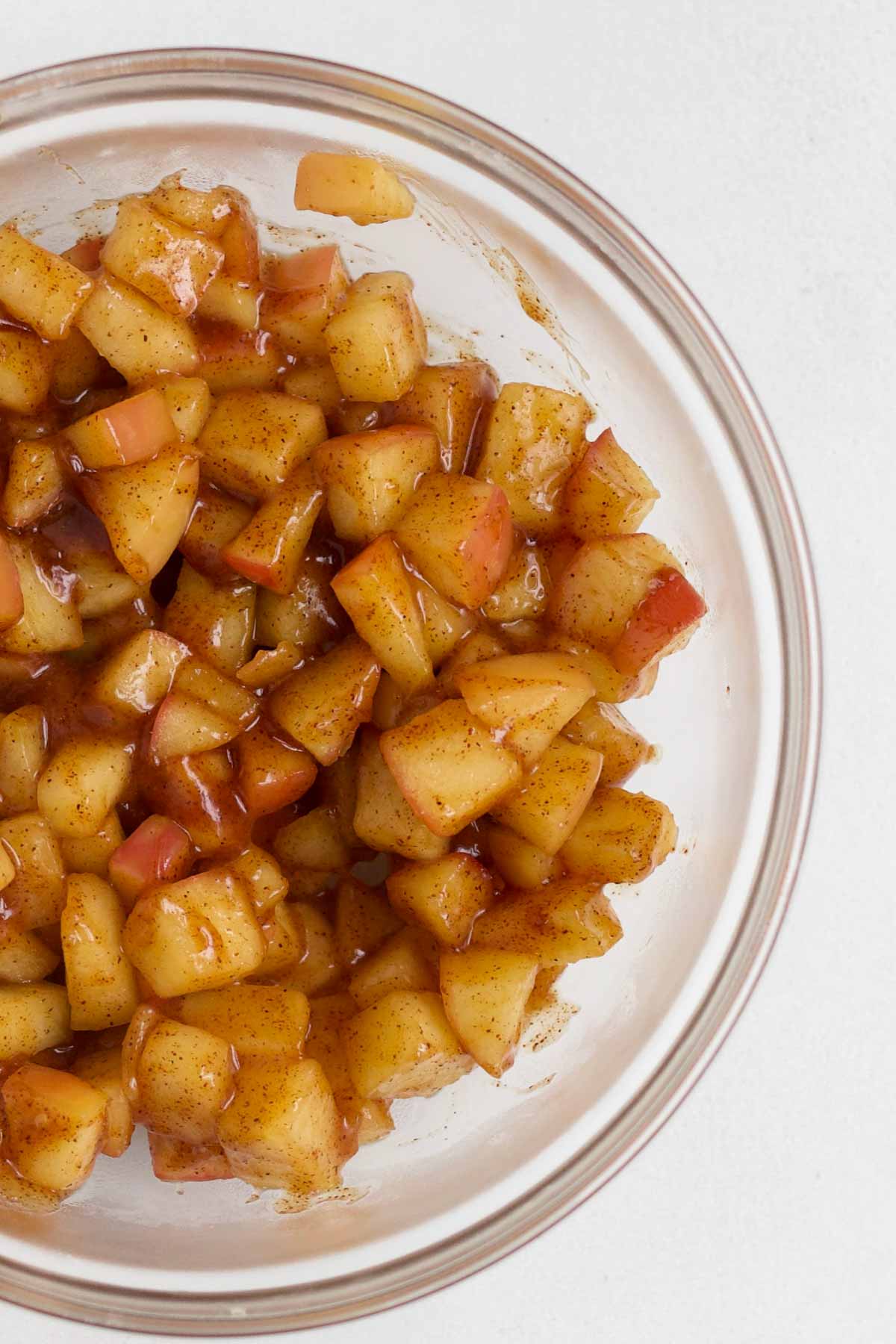 Sugary and warm apple pie filling in a bowl.