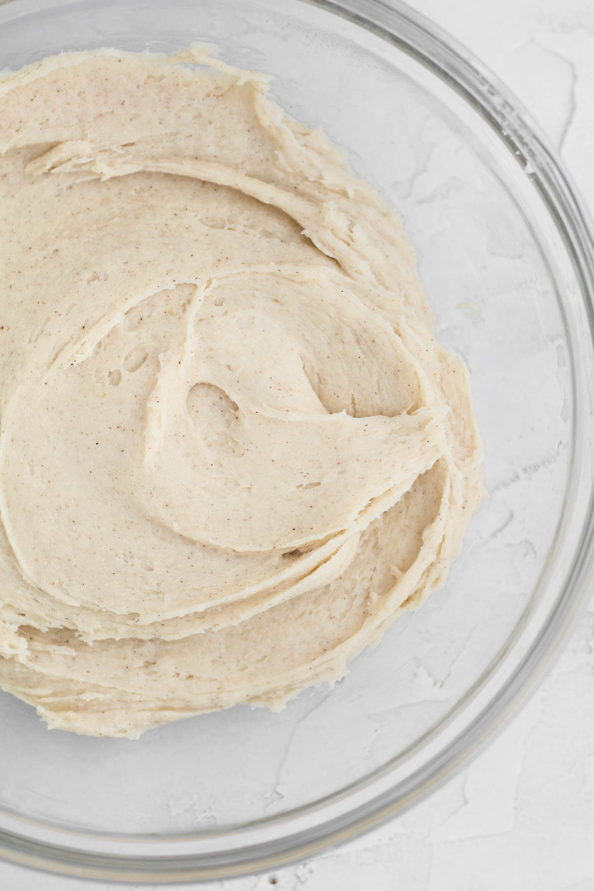 Mixing in the dry ingredients into a cookie dough batter.