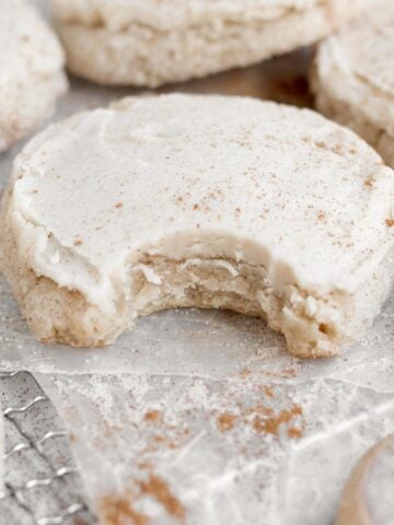 A bite reveals the delicious warm interior of the Applesauce Cookie with Brown Sugar Frosting.