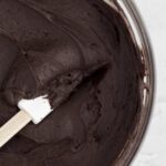 Sweet, luscious and silky smooth Chocolate Cream Cheese Frosting in a bowl with a spatula.